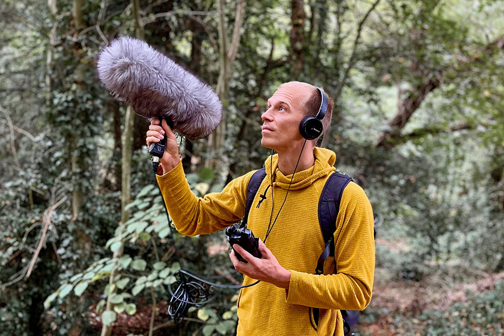 Recording sounds in a forest.