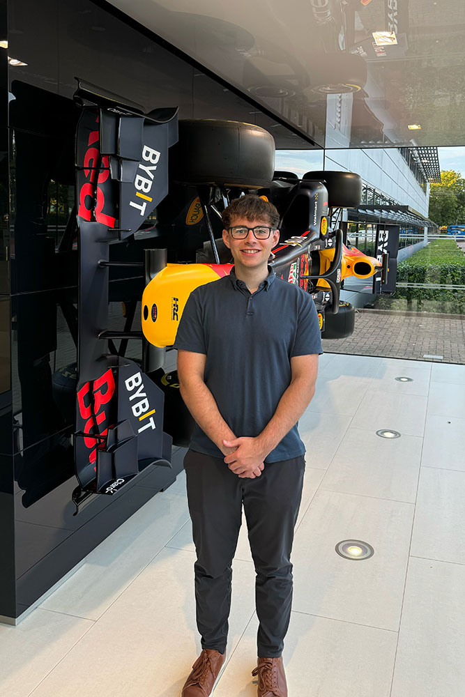 Man standing in front of race car.