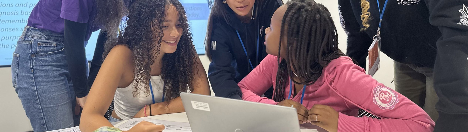 Group collaborating around a laptop.
