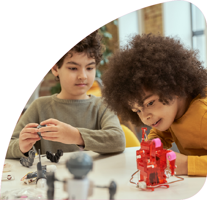 Children building robots with materials.